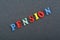 PENSION word on black board background composed from colorful abc alphabet block wooden letters, copy space for ad text. Learning