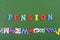 PENSION word on green background composed from colorful abc alphabet block wooden letters, copy space for ad text