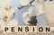 PENSION word written on wood block