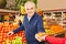 Pensioner buying vegetables at the supermarket