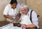 Pensioner eating with help of a nurse