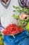 Pensioner farmer in garden holding plate full of red currants