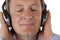 Pensioner with headphones listening to mp3 music