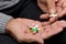 Pensioner holds a lot of colored pills in old hands. Painful old age. Health care of older people