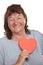 Pensioner holds red heart