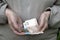 A pensioner holds small Ukrainian hryvnia money, banknotes and coins in her hands