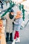 Pensioner hugging his wife and pointing to the street food