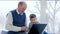 Pensioner internet communication, grandfather with grandson waving to laptop and hug each other at home