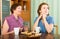 Pensioner mother and her daughter tea-drinking