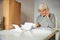 Pensioner with a pen in her hand scrutinizing the documents