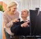 Pensioner sitting together at the computer