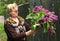 Pensioner woman in her country estate with lilac flowers bouquet