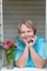 Pensioner woman at window speaking by phone