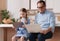 Pensioner and young girl using digital devices at home