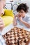 Pensive arabian boy playing chess near