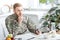 pensive army soldier sitting at kitchen table and writing while