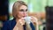 Pensive beautiful business woman drinking coffee from cup relaxing enjoying break medium close-up