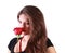 Pensive beautiful woman sniffs red rose