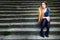 Pensive beautiful woman on stone steps