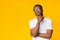 Pensive Black Guy Thinking Standing On Yellow Background, Studio Shot