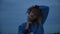 Pensive blonde posing against a cloud background