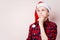 Pensive boy in christmas hat thinking of something