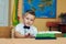 Pensive boy in class in elementary school . The concept of primary education