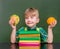 Pensive boy with orange and hamburger