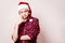 Pensive boy in Santa red hat thinking of something