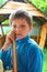 Pensive boy in summer wooden gazebo