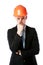 Pensive businessman in orange helmet
