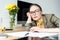 pensive businesswoman in eyeglasses leaning at table and looking away