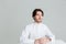 Pensive calm man in white shirt sitting at the table