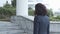 Pensive Caucasian businesswoman in suit walking upstairs