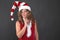 Pensive Christmas woman on grey background