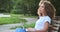 Pensive creative mixed race business female planning work use laptop pc relaxing on bench park