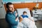 Pensive dad standing near sick son in hospital bed