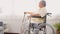 Pensive disabled elderly patient sit on wheelchair alone