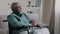 Pensive dreaming calm alone elderly patient old African bald man with gray beard senior mature grandpa sit on wheelchair