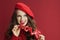 Pensive elegant 40 years old woman in red sweater and beret