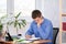 Pensive employee reads business papers in the office