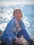 Pensive fair-haired woman chilling at sea background.