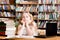 Pensive female student in library