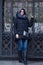 Pensive girl posing against a vintage wrought-iron gate