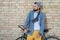 Pensive hipster man with bicycle looking away on street