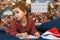 Pensive little girl writing letter to santa. kid making a wish, gift, present on new year eve. child dreaming under the christmas