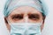 Pensive male doctor. Thinking doctor. Face in a medical mask close-up. A puzzled look