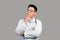 Pensive mature chinese guy therapist in white coat and glasses thinks and looks at free space