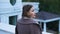 Pensive middle-aged woman standing on balcony of estate, feeling sad and lonely