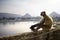 Pensive monkey sitting in front of pushkar lake in rajasthan, in